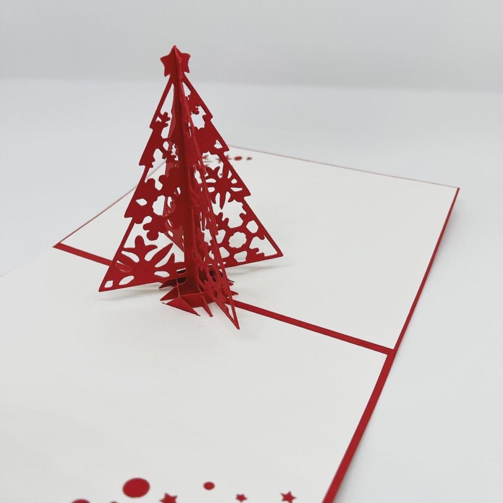 Rote Pop-up-Weihnachtskarte mit einem dreidimensionalen Tannenbaum aus Papier