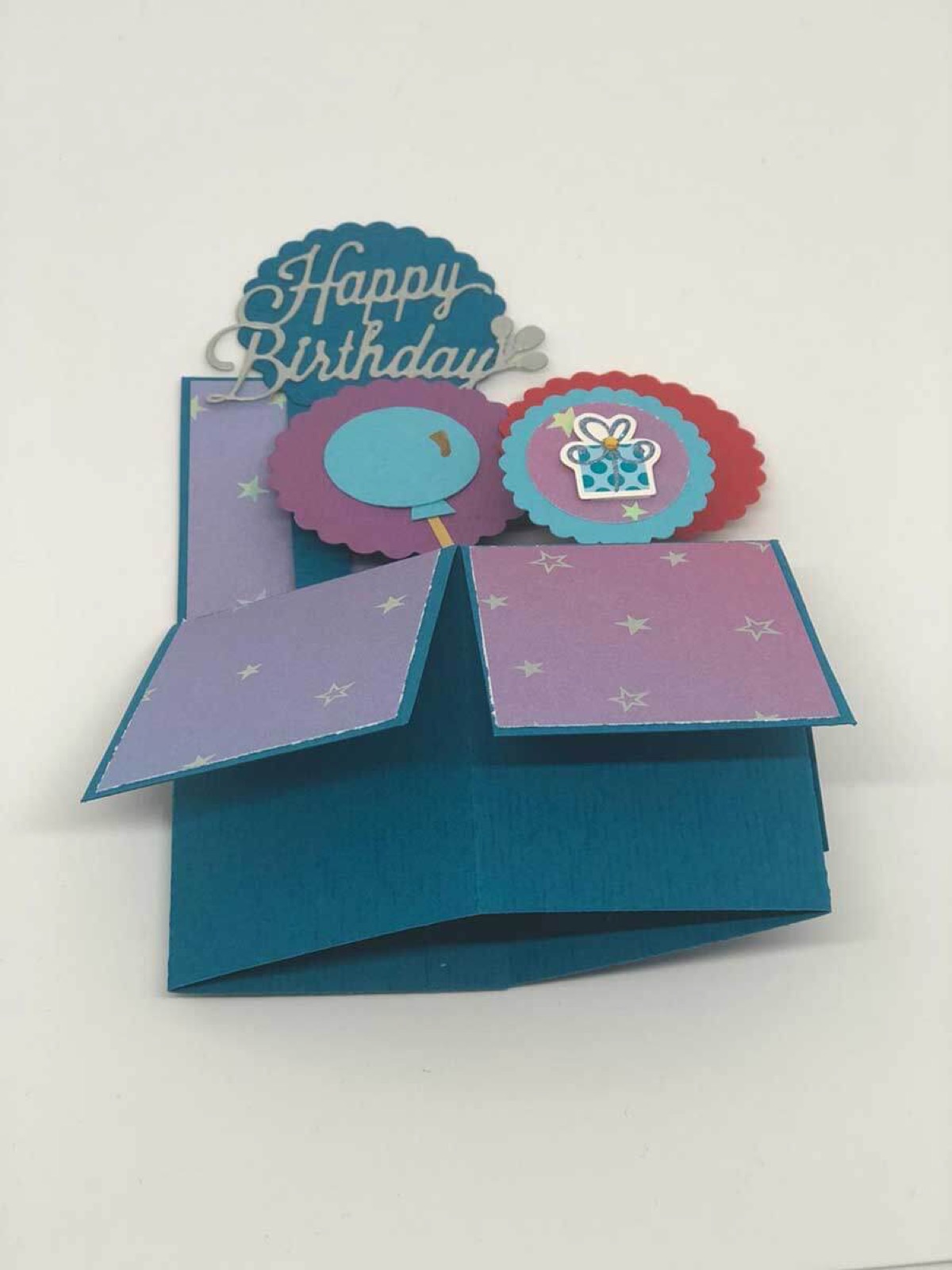 Aufgeklappte Karte mit Happy-Birthday-Ballons in Türkis und Flieder