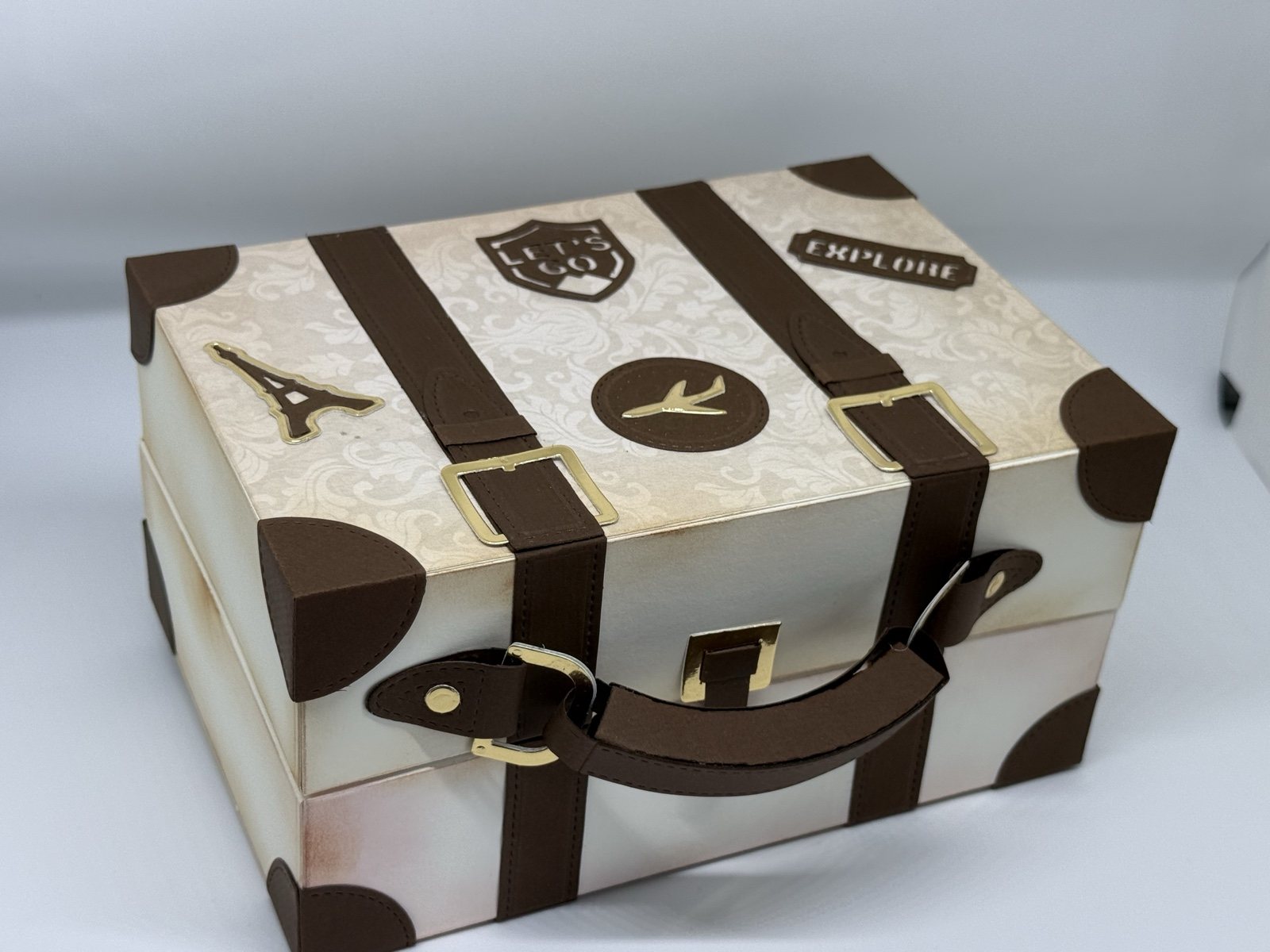Reisekoffer-Box von schräg oben mit Eiffelturm- und Flugzeug-Emblem